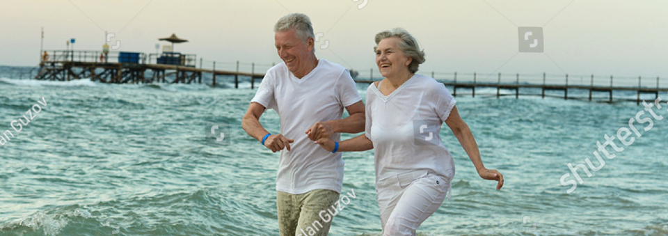 stock-photo-amusing-elderly-couple-went-to-the-beach-to-have-a-walk-by-sea-181935761